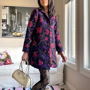 Black 3/4 length jacket with textured floral design and gold threaded detail